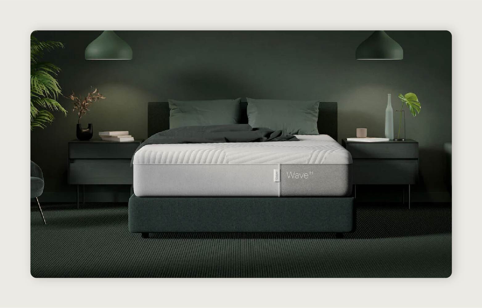 The Casper Wave Hybrid Mattress™ placed centrally in a dark green room with overhead lights and green plants. 