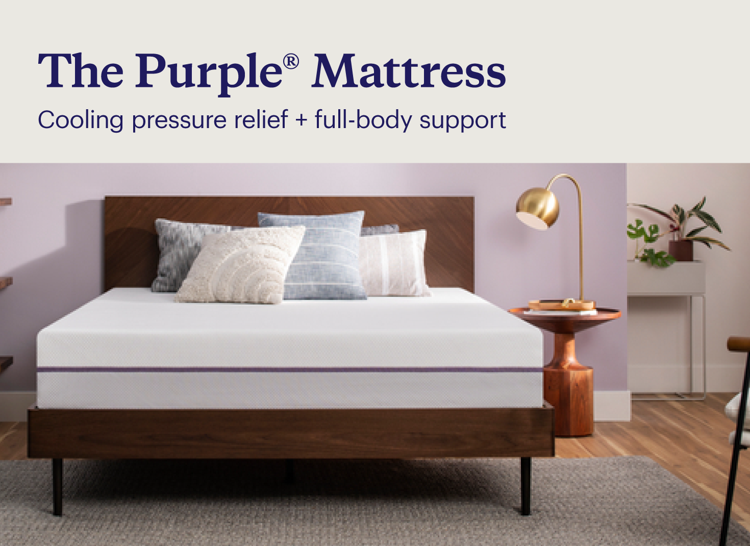 Key features of the Purple plus® mattress shown with the unmade mattress on a modern wood bed frame in a boho bedroom.