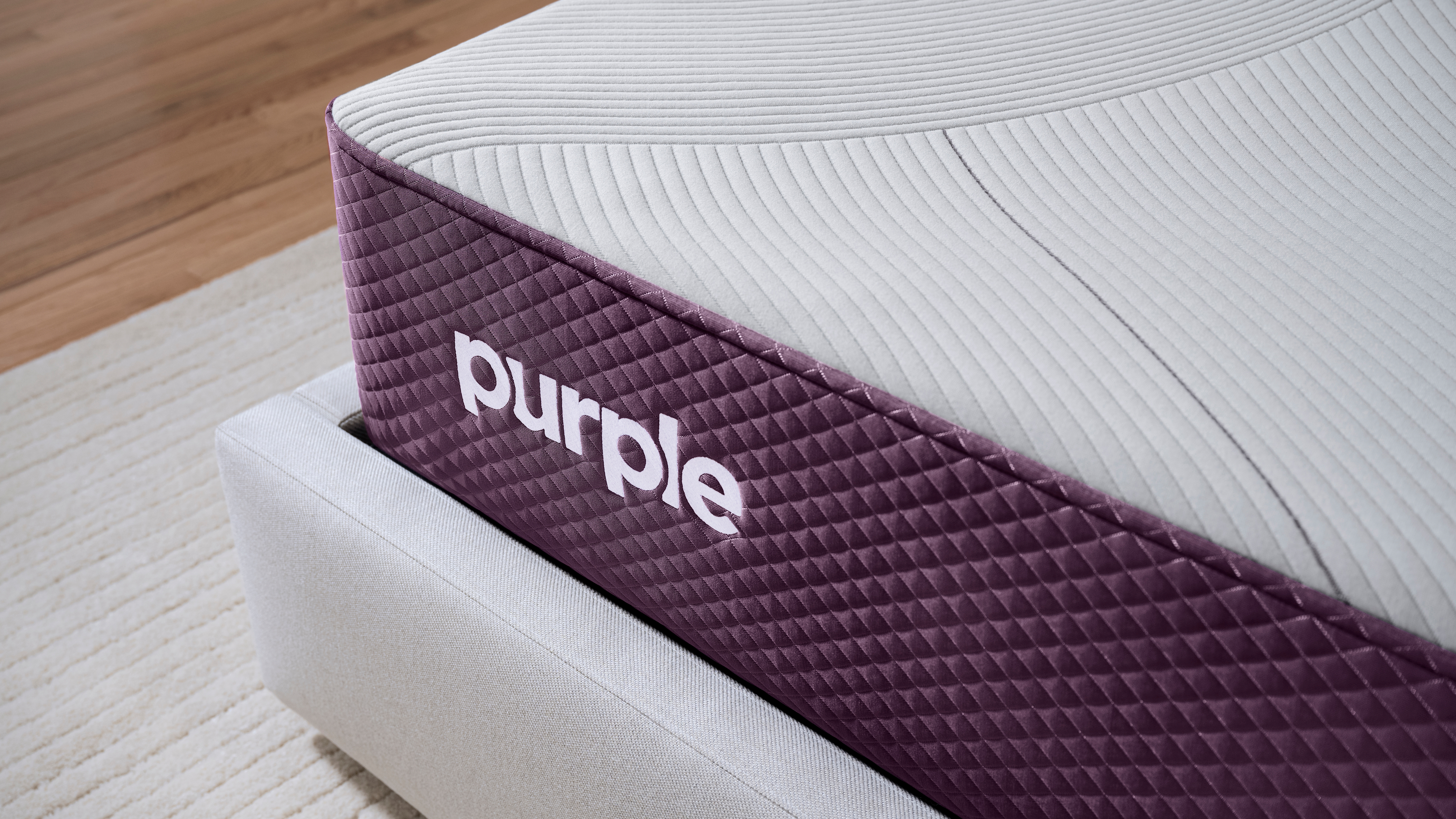 Corner of a Purple Restore Hybrid mattress.