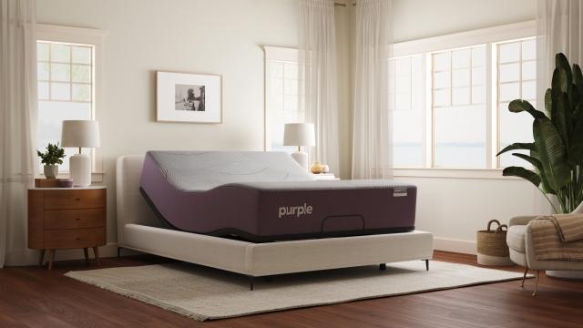 Purple RestorePremier Hybrid mattress on the Purple Premium Smart Base in a bright bedroom.
