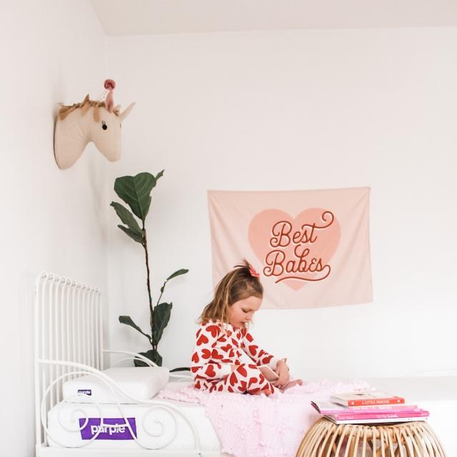 kid on purple mattress