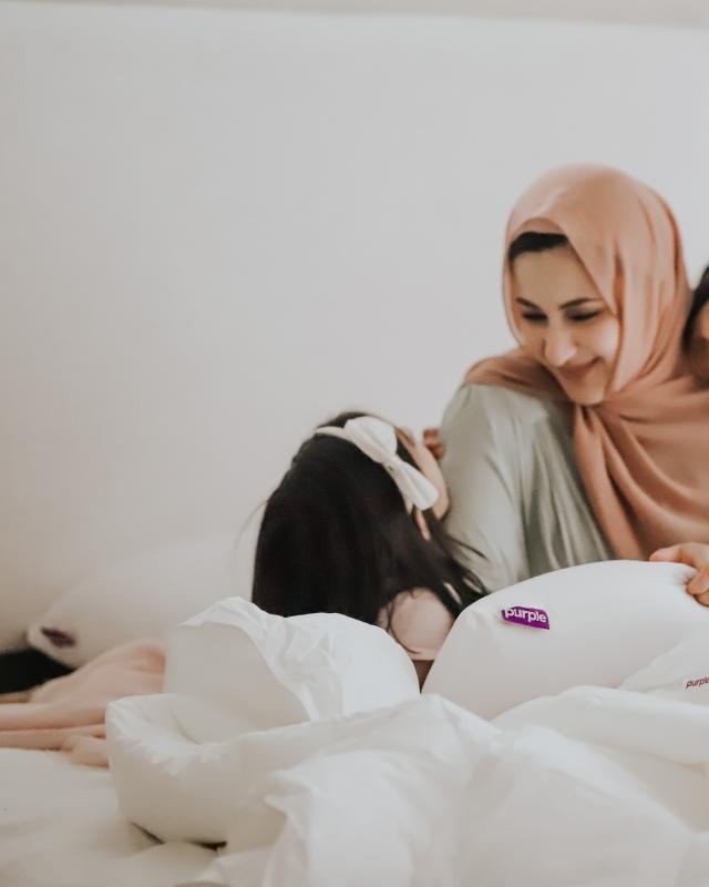 mother in bed with two daughters