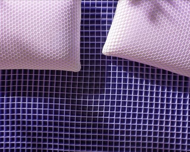 Exposed gid Harmony pillows on a Purple mattress