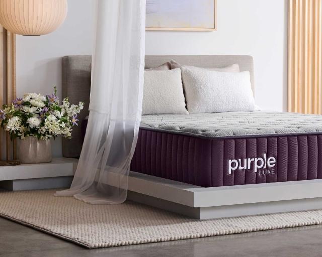 The thick Purple Rejuvenate™ Mattress on a modern bed frame in a bedroom.