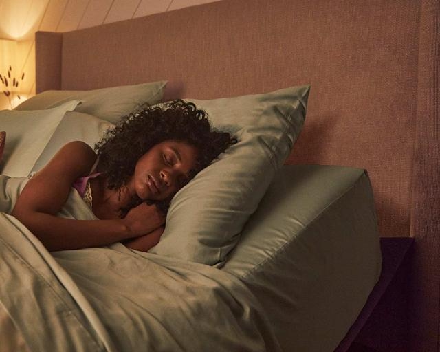 Women sleeping on elevated mattress.