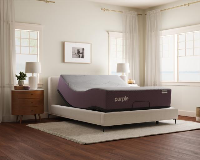 Purple RestorePremier Hybrid mattress on the Purple Premium Smart Base in a bright bedroom.