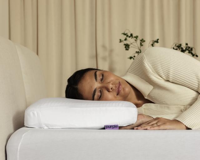 Person sleeping on a Purple pillow.