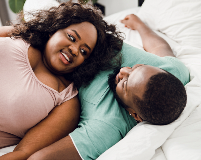 A plus size couple sleeping on a hybrid mattress.