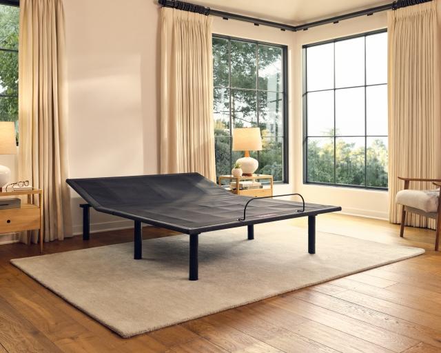 A Purple Adjustable Base in a well-lit bedroom.
