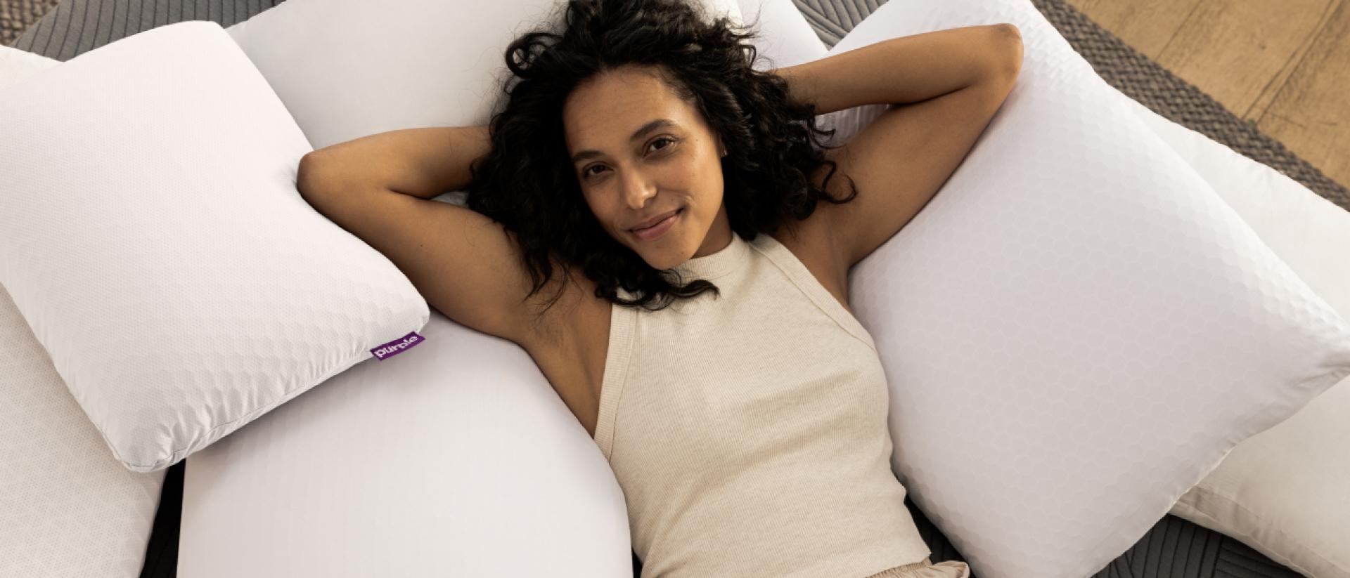 woman laying on pile of pillows