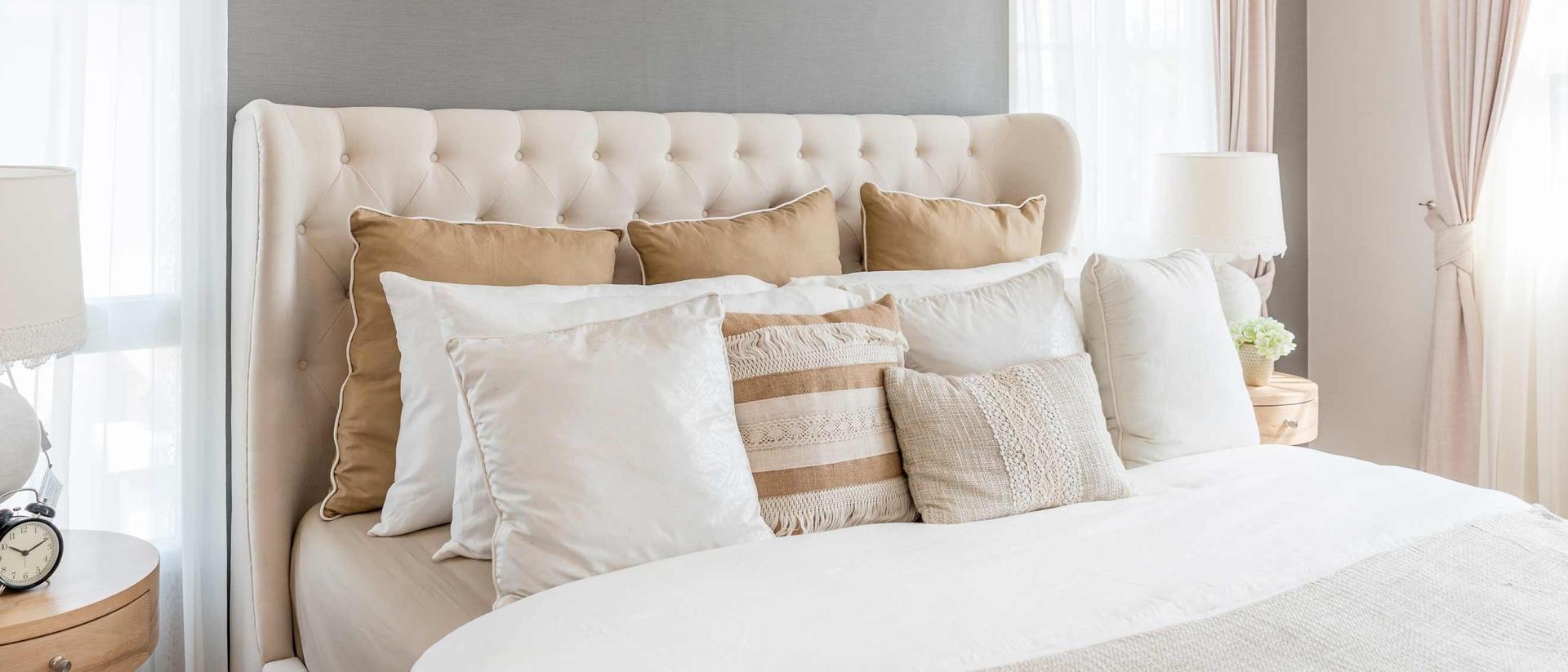 Photo of a bed with numerous different size pillows