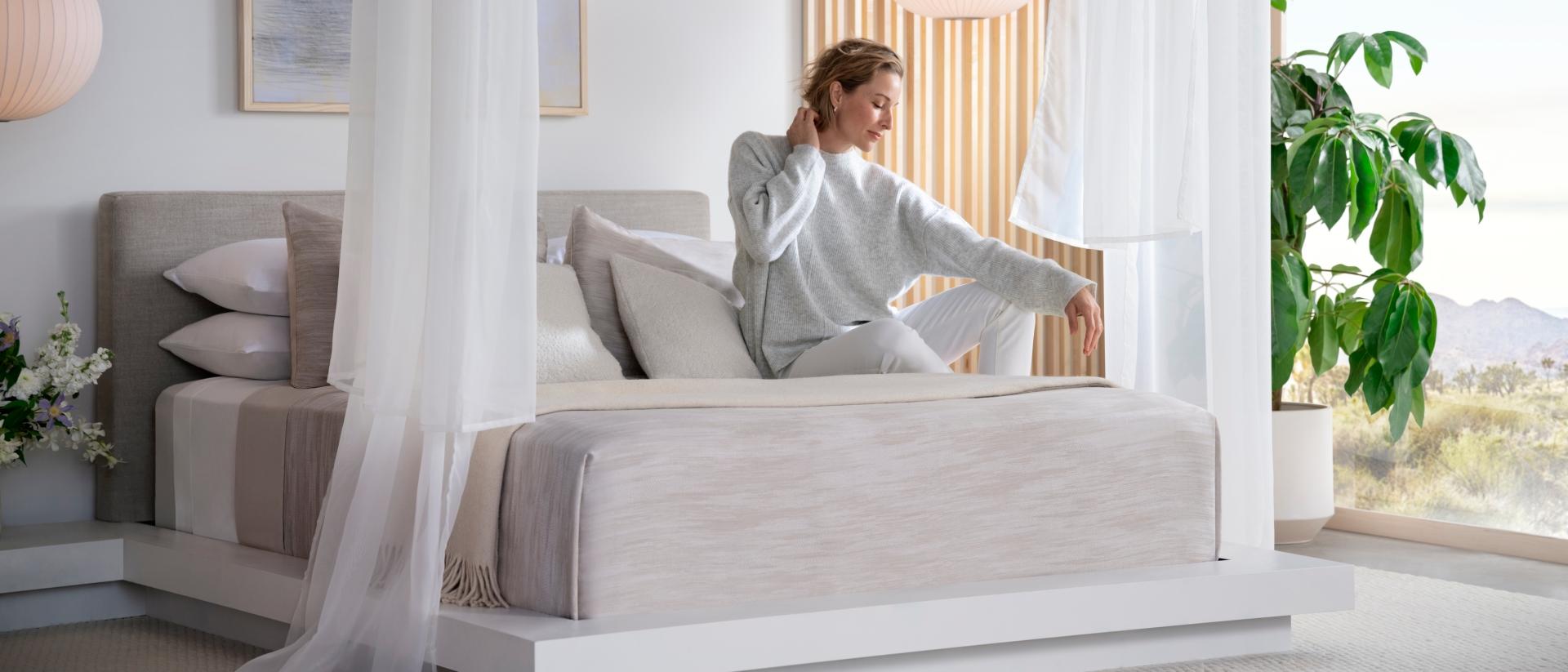 A woman waking up on a Purple Rejuvenate mattress.