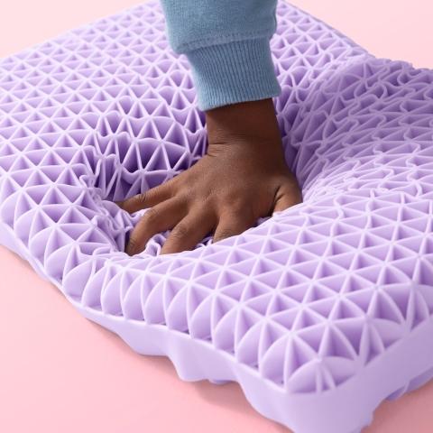 Kid's hand squishing Kid Purple Pillow