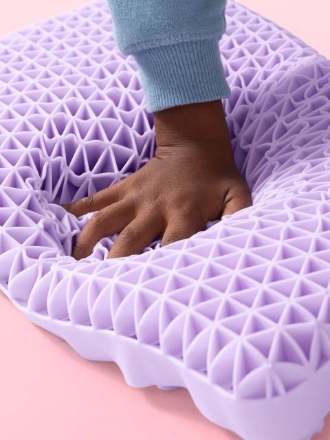 Kid's hand squishing Kid Purple Pillow